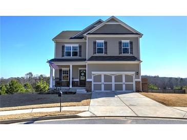 Two story house with gray siding, brick accents, and a three-car garage at 201 Augusta Walk, Canton, GA 30114