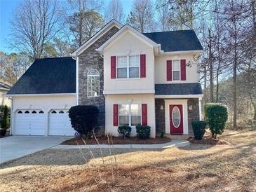 Two-story house with stone accents, red shutters, and a two-car garage at 4299 High Country Dr, Douglasville, GA 30135