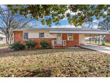 Brick ranch house with carport and mature trees at 114 Woodhaven Dr, Stockbridge, GA 30281