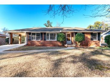 Brick ranch house with a landscaped yard and driveway at 3414 Alcan Way, Tucker, GA 30084