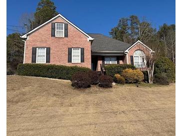 Brick house with gray roof, landscaping, and a partially visible deck at 790 Hiram Davis Rd, Lawrenceville, GA 30045