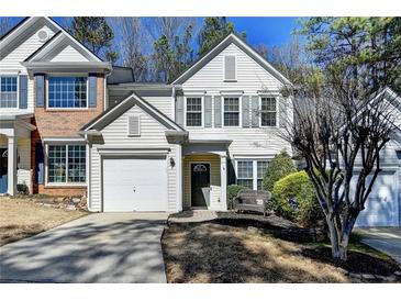 Charming two-story home features a one-car garage and welcoming front entrance at 221 Kenninghall Se Ln, Smyrna, GA 30082