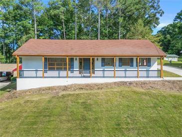 Newly renovated ranch home featuring a large front porch and a beautifully landscaped lawn at 2815 Spain Dr, East Point, GA 30344