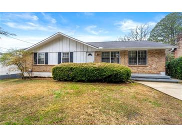 Brick ranch house with a well-maintained lawn at 64 Valley Hill Sw Rd, Riverdale, GA 30274