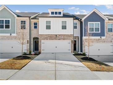 Three-unit townhome development showcasing charming brick and siding exteriors at 5595 Hislop Lane # 77, Mableton, GA 30126