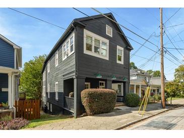 Dark gray exterior of charming two-story home with a well-manicured front yard at 66 Howell Ne St, Atlanta, GA 30312