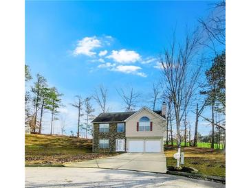 Two-story house with stone accents and a two-car garage at 6921 Foxmoor Way, Douglasville, GA 30134