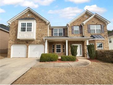 Two story brick home with a two car garage and manicured lawn at 2756 Palmview Sw Ct, Atlanta, GA 30331