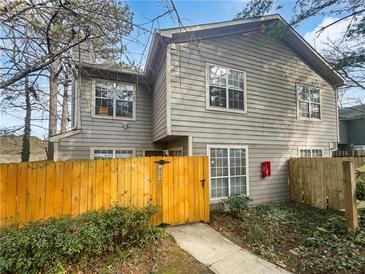 Gray two-story house with a wooden fence and gate at 1089 Brittwood Pl, Norcross, GA 30093