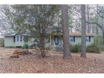 Charming ranch-style home featuring a well-maintained front yard and a cozy entrance at 180 Sears Cir, Covington, GA 30016