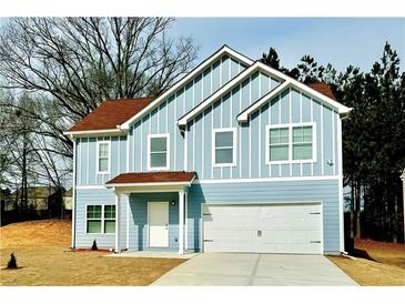 Two-story light blue house with white accents and a brown roof at 4405 Belcamp, Fairburn, GA 30213