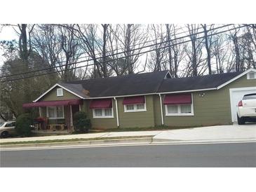 Ranch-style home with maroon awnings and a detached garage at 1004 Marietta Rd, Canton, GA 30114