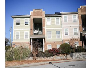 Exterior view of condo featuring balcony, traditional windows, and neat landscaping at 1752 Sw Pryor Sw Rd # 105, Atlanta, GA 30315