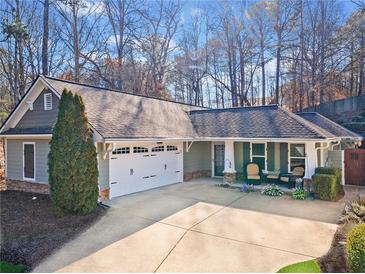 Charming single-story home with a well-manicured front yard and an attached two-car garage at 320 Jessica Way, Canton, GA 30114