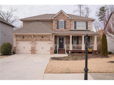 Charming two-story home featuring a two-car garage and inviting front porch at 1320 Newbridge Cir, Buford, GA 30519