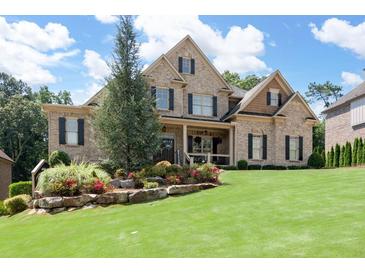 Brick two-story house with a landscaped lawn and mature trees at 4668 Andrea Pointe, Marietta, GA 30062