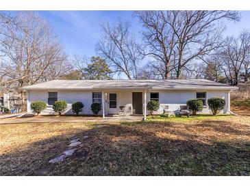 White brick duplex with mature trees and landscaping at 2698 George Nw St, Atlanta, GA 30318