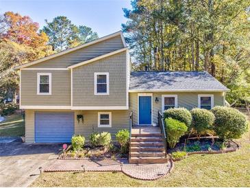 Attractive ranch home with a landscaped yard and attached garage at 3700 Ashley Woods Dr, Powder Springs, GA 30127