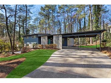 Charming exterior of a two-story home featuring a carport and manicured lawn at 3732 Summitridge Dr, Atlanta, GA 30340