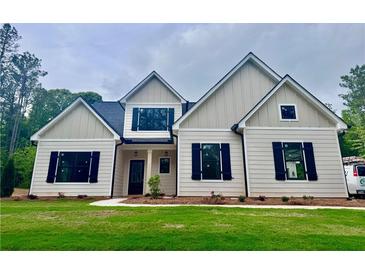 New construction home with traditional architecture, black shutters, neutral siding, and well-maintained lawn at 130 West Lake Blvd, Carrollton, GA 30116