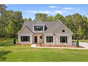 Charming home featuring a well-manicured lawn and neutral exterior with black shutters at 130 West Lake Blvd, Carrollton, GA 30116