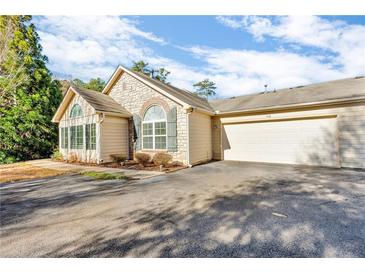 Inviting exterior with stone accents and a two-car garage at 418 Kenley Ct, Mcdonough, GA 30253