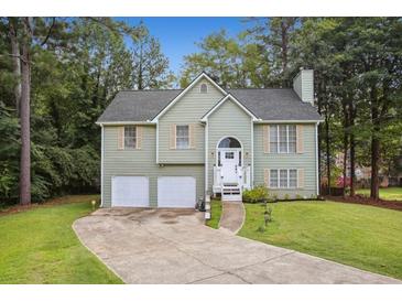 Two-story house with attached garage and landscaped yard at 5076 Furlong Way, Powder Springs, GA 30127