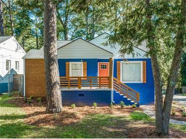 Charming blue house with white trim, wood accents and a landscaped yard at 1565 Ocala Sw Ave, Atlanta, GA 30311