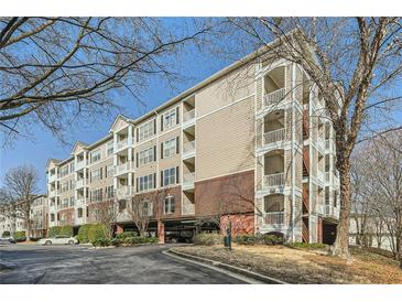 Low angle shows condo exterior with multiple balconies and covered parking beneath the building at 4333 Dunwoody Park Dr # 3406, Dunwoody, GA 30338