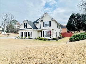 Charming two-story home with classic architecture and well-manicured landscaping at 100 Cottonwood Pl, Stockbridge, GA 30281