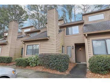 Charming multi-level townhome with cozy curb appeal, mature landscaping, and convenient parking at 1403 Parkaire Xing, Marietta, GA 30068