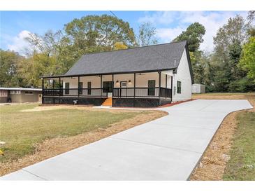 Newly constructed home with front porch and driveway at 4280 Atlanta St, Powder Springs, GA 30127