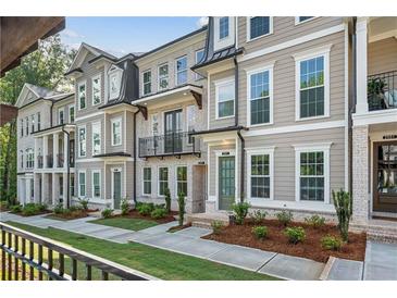 Charming townhome exterior with manicured landscaping, brick accents, and neutral colors at 2531 High Brow St # 41, Duluth, GA 30096