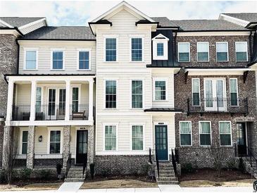 Beautifully designed townhomes feature a mix of brick and siding, with front porches and symmetrical windows at 2531 High Brow St # 41, Duluth, GA 30096