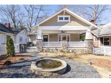 Charming craftsman-style home featuring a welcoming front porch with stone accents and a lovely front yard with a fountain at 536 Moreland Ne Ave, Atlanta, GA 30307