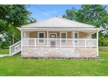Cute cottage with a large front porch and stone accents at 1847 New Ne St, Conyers, GA 30012