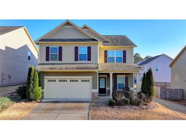 Charming two-story home boasts a two-car garage and inviting front porch in a well-maintained community at 831 Pine Arbor Ln, Lawrenceville, GA 30043