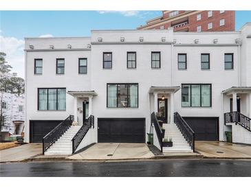 Stunning white brick townhomes featuring black trim and attached garages, offering modern elegance at 3667 Peachtree Ne Rd # 16, Atlanta, GA 30319