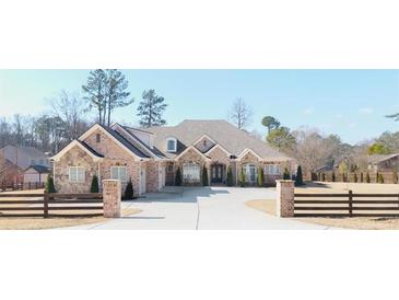 Brick house with a large driveway and three-car garage at 2195 Morgan Ne Rd, Marietta, GA 30066