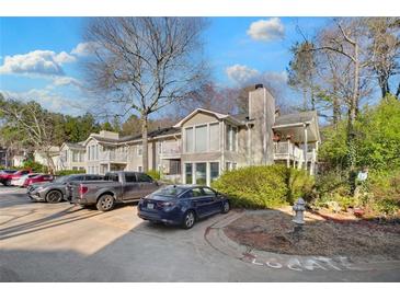 Tan multi-unit building with parking and landscaping at 2006 Augusta Se Dr, Marietta, GA 30067