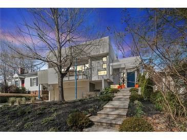 Modern home featuring a unique design, landscaped front yard, and eye-catching architectural details at 727 Berkeley Nw Ave, Atlanta, GA 30318