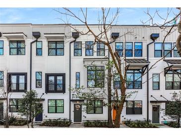 Charming townhomes with sleek black window frames, modern white siding, and manicured landscaping at 1260 Wright Se Ln, Atlanta, GA 30316