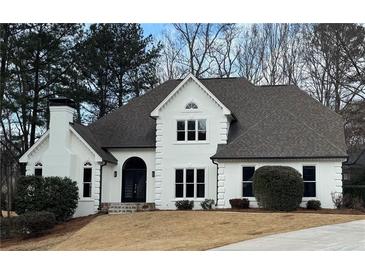 Two-story house with white exterior, dark roof, and landscaping at 9240 Prestwick Club Dr, Duluth, GA 30097