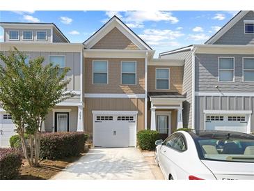 Charming townhome featuring a one-car garage, neutral exterior colors, and well-maintained landscaping at 2657 Avanti Way, Decatur, GA 30035