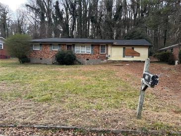 Brick ranch house with a large front yard and mature trees at 126 Meadow Park Sw Ln, Atlanta, GA 30315