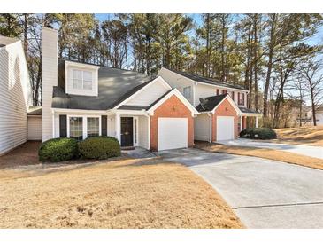 Brick front townhouse with attached garage and landscaping at 849 Hillandale Ln, Lithonia, GA 30058