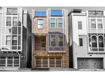 Stylish exterior elevation showcasing a modern townhome design with a garage and large windows at 607 Broadview Ter, Atlanta, GA 30324