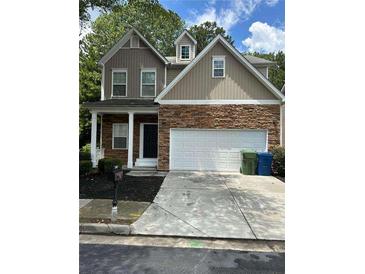 Two-story house with stone and siding accents, a two-car garage, and a landscaped yard at 3301 Cascade Parc Blvd, Atlanta, GA 30311