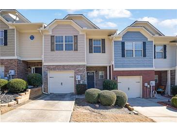 Attractive townhomes featuring attached garages and manicured landscaping for curb appeal at 55 Burns View Ct, Lawrenceville, GA 30044