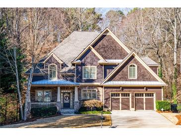 Charming two-story home with brown siding, stone accents, and a well-maintained front yard at 2240 Palmour Ct, Atlanta, GA 30337